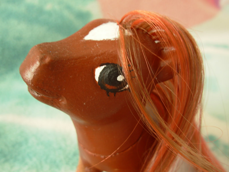 A brown G3 MLP with brown and natural red mane/tail, a white star on her forehead, brown eyes