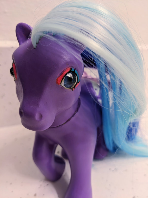A closeup of the blue twinkle eyes and eyeshadow of Spyhopper